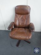 A late 20th century brown leather swivel relaxer chair