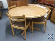 A circular pedestal kitchen table and four chairs