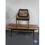 A 1970's Danish teak coffee table and a teak framed armchair