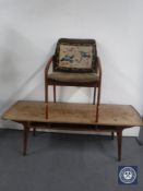 A 1970's Danish teak coffee table and a teak framed armchair