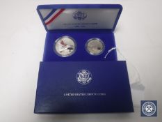 A United States of America silver proof 1986 Liberty half dollar and full dollar, cased.