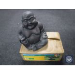 A boxed little barrel fountain and a Buddha figure