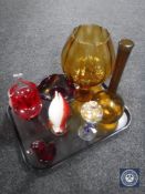 A tray of seven pieces of coloured glass ware including two amber glass vases, ruby bowl and basket,