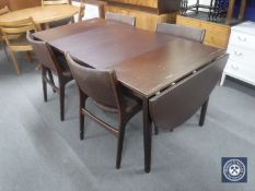 A late 20th century mahogany flap sided dining table with two leaves and four chairs