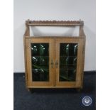 A continental oak wall cabinet with leaded glass doors