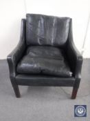 A mid 20th century black leather armchair