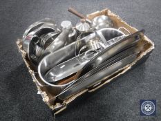 A box of stainless steel dishes and trays, pan with burner,