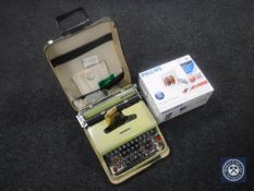 A cased Olivetti 22 typewriter and Philips digi photo frame