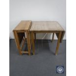 A pine flap sided dining table and a pine drop leaf table