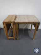 A pine flap sided dining table and a pine drop leaf table