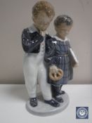 A Royal Copenhagen figure - boy and girl