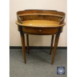 A reproduction mahogany oval writing table,