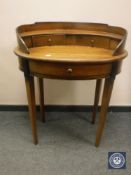 A reproduction mahogany oval writing table,