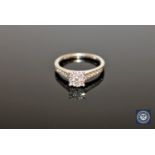 A platinum and diamond cluster ring set with diamond shoulders, size K 1/2.