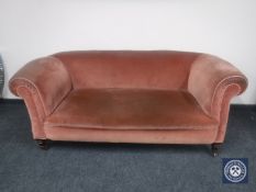 A Victorian drop end Chesterfield settee upholstered in pink dralon