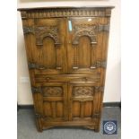 A good quality carved oak cocktail cabinet,