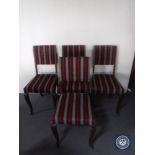A set of four oak dining chairs in striped fabric