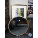 A 1930's oval mirror, gilt picture of Bamburgh castle,