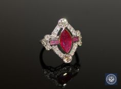 An 18ct white gold ruby and diamond ring, a central marquise-cut deep red ruby weighing 1.