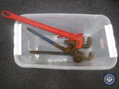 A crate of three heavy duty wrenches and a small pipe bender