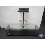 A Heine design glass topped coffee table and a gas lift bar stool