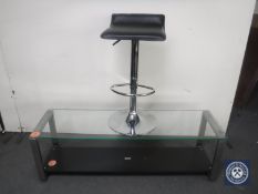 A Heine design glass topped coffee table and a gas lift bar stool