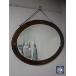 A late Victorian oval inlaid mahogany framed mirror