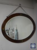 A late Victorian oval inlaid mahogany framed mirror