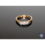 An 18ct gold three stone ring, approximately 0.33ct, size K.