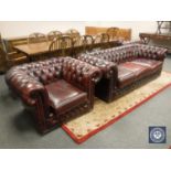 An oxblood leather Chesterfield three seater settee and pair of club armchairs