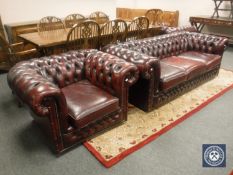 An oxblood leather Chesterfield three seater settee and pair of club armchairs