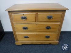 An Edwardian pine four drawer chest