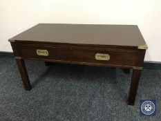 A mahogany ship's style coffee table with brass handles and mounts