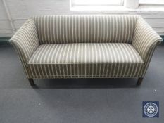 A 20th century settee upholstered in a striped fabric