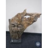 A Greenman wooden carving on stand