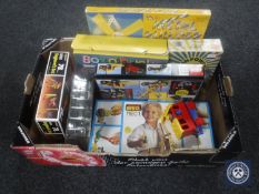 A box containing assorted construction kits including Lego,