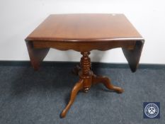 A Victorian mahogany flap sided pedestal table