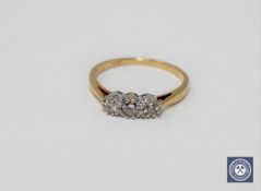 An 18ct gold three stone diamond ring, approximately 0.2ct.