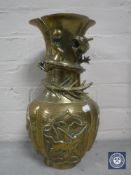A Chinese embossed brass vase of dragon design,