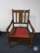 A 20th century oak commode chair