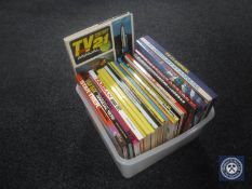 A box containing mid 20th century annuals and books including Star Trek,