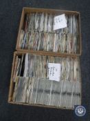 Two boxes containing 7" singles including Guns N' Roses, Paul Weller, Madonna, The Clash,