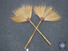 A pair of bamboo handled African fly swatters