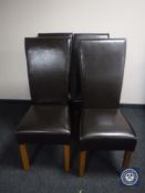 A set of four brown leather high back dining chairs