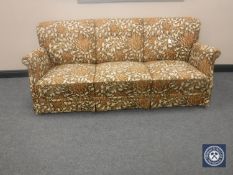 A mid 20th century continental three seater settee upholstered in a floral fabric