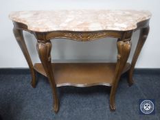 A French walnut two-tier side table with a marble top