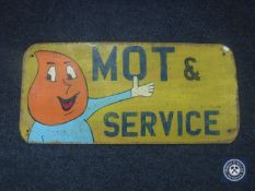 A hand painted MOT and Service sign on board
