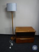 A teak glass door entertainment stand together with a teak standard lamp with shade