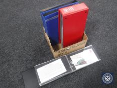 A box of two albums first day covers together with four folders of stamps of the world on sheets