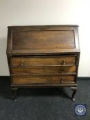 A Victorian mahogany writing bureau on claw and ball feet